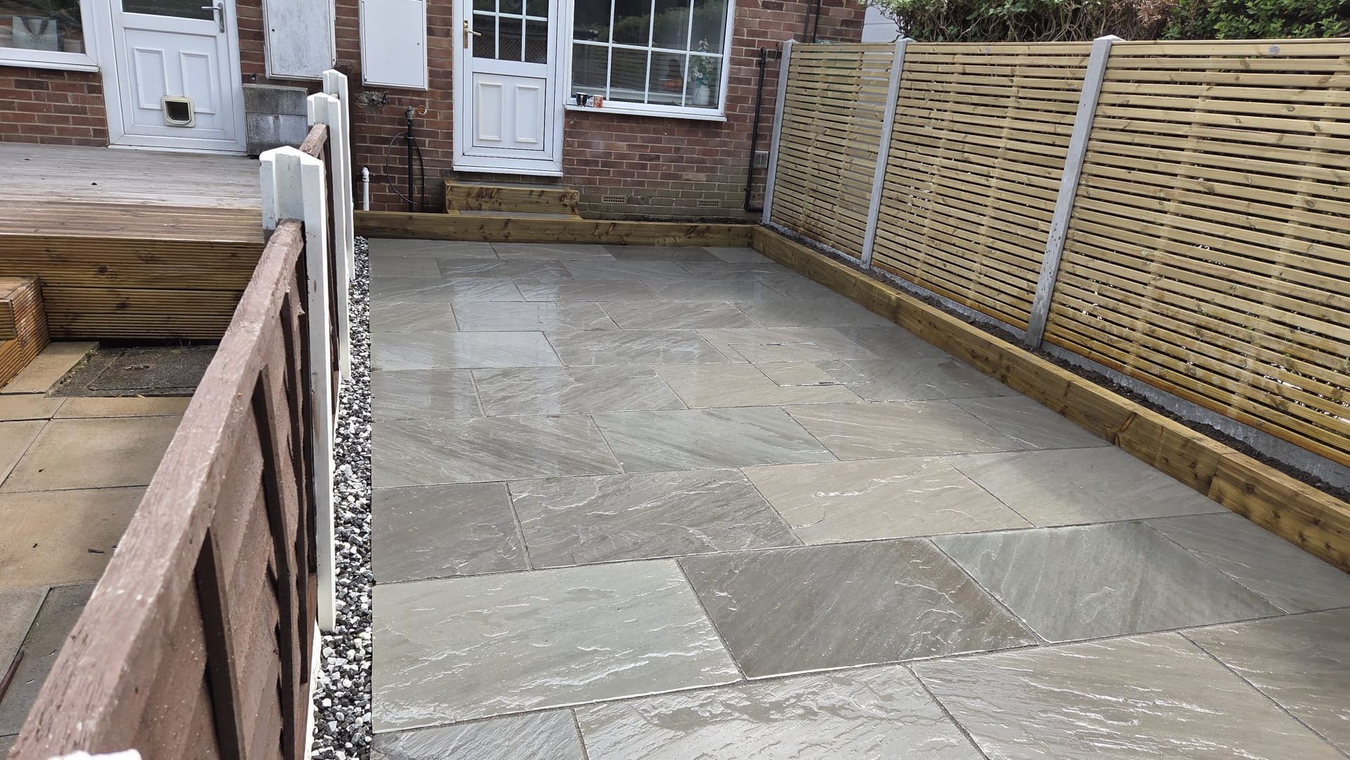 Kandla Grey Indian stone with fencing, sleeper planters and steps in Farsley