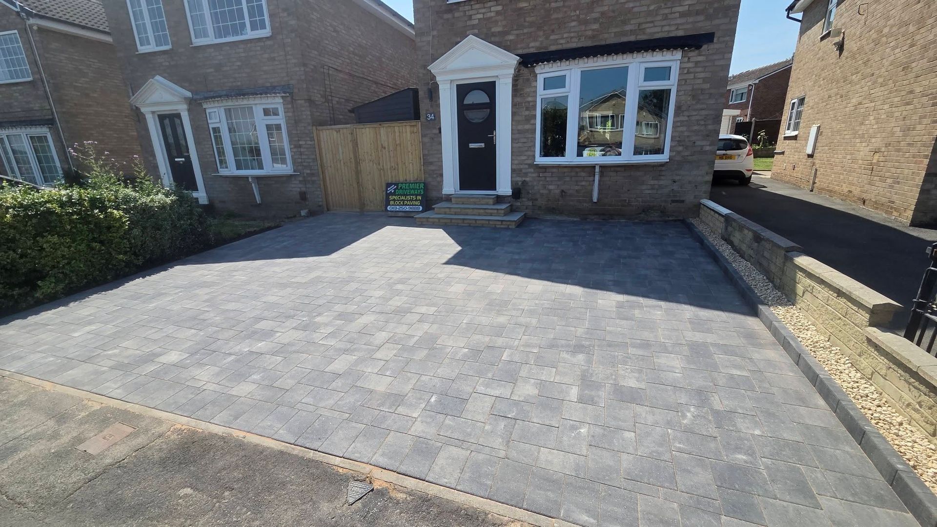 Completed grey block paving driveway in Farsley with charcoal borders and entrance steps
